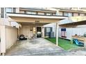 Townhome exterior with covered parking, grassy yard, and patriotic decor at 4846 Twin Lakes Trl, Atlanta, GA 30360