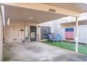 Inviting front exterior featuring a well-kept carport and a cozy patio with artificial turf at 4846 Twin Lakes Trl, Atlanta, GA 30360