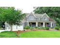 Beautiful exterior featuring manicured lawn, mature trees, and a painted brick home with a large garage at 1178 Chambord Ne Way, Brookhaven, GA 30319