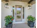 Elegant front door with sidelights and potted plants for a warm, inviting entrance at 4446 Huntington Cir, Atlanta, GA 30338