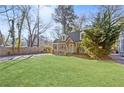 Eye-catching exterior of a home with a sprawling green lawn, mature trees, and a cozy, inviting curb appeal at 1824 Westwood Sw Ave, Atlanta, GA 30310