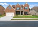 Attractive two-story brick home with a well-kept lawn and attached two-car garage at 3652 Terrah Point Dr, Duluth, GA 30097