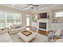 Bright living room with fireplace, hardwood floors, coffered ceilings, and large windows at 4000 Chastain Preserve Ne Way, Atlanta, GA 30342