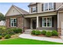 Inviting front porch with stone accents, manicured landscaping, and an elegant entrance, creating curb appeal at 147 Longleaf Dr, Canton, GA 30114