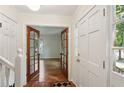 Inviting entryway with hardwood floors and elegant french doors leading into the living room at 5240 Arrie Way, Atlanta, GA 30360