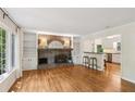 Bright living room with a brick fireplace, built-in bookshelves, and hardwood floors at 5240 Arrie Way, Atlanta, GA 30360
