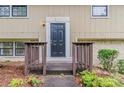 Close-up of the front door with brown railings and a walkway leading to the entrance at 2139 Jonathan Ave, Lithonia, GA 30058