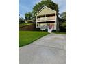Charming two-story home featuring double porches, a concrete drive, and a red front door at 2650 Batavia St, East Point, GA 30344