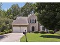 Charming two-story home with attached two car garage and well-maintained lawn at 3850 Stepney Way, Cumming, GA 30041