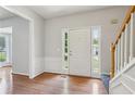 Bright foyer featuring hardwood floors and staircase with wooden handrail at 3850 Stepney Way, Cumming, GA 30041
