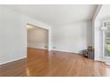 Bright living room with hardwood floors and large window overlooking the yard at 3850 Stepney Way, Cumming, GA 30041