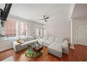 Bright living room with large gray sectional, hardwood floors, and plenty of natural light at 1735 Peachtree Ne St # 117, Atlanta, GA 30309