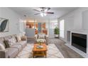 Cozy living room features neutral colors, a fireplace, and an open layout leading to the kitchen at 2191 Phillips Rd, Lithonia, GA 30058
