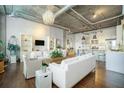 Spacious living area with white furnishings flowing seamlessly into the open kitchen with bar seating at 3235 Roswell Ne Rd # 402, Atlanta, GA 30305