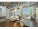 Beautifully designed living room featuring hardwood floors, white sofas, and unique decor throughout the space at 3235 Roswell Ne Rd # 402, Atlanta, GA 30305