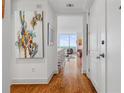 Inviting condo hallway features wood floors, art, and leads to bright living spaces at 3630 Peachtree Ne Rd # 2309, Atlanta, GA 30326