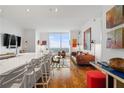 Open living space with a modern design, wood floors, floor-to-ceiling windows, and stylish furniture at 3630 Peachtree Ne Rd # 2309, Atlanta, GA 30326