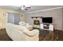 Cozy living room featuring a brick fireplace, neutral tones, and wood-look floors at 5343 Crystal Ln, Atlanta, GA 30349
