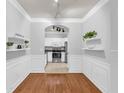 Dining room features hardwood floors, white molding, and open access to the white kitchen at 1850 Cotillion Dr # 3123, Atlanta, GA 30338