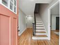 Inviting entryway with a staircase, hardwood floors, and a brightly colored front door at 4617 Cedar Park Dr, Stone Mountain, GA 30083
