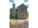 Back exterior featuring a brick patio and door with glass at 112 Lexington Parke Dr, Woodstock, GA 30189