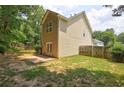 Backyard featuring a small brick patio, lawn, and wood fence at 112 Lexington Parke Dr, Woodstock, GA 30189