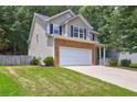 Charming two-story home featuring a two-car garage, stone accents, and a well-manicured lawn at 112 Lexington Parke Dr, Woodstock, GA 30189