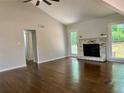 Bright living room with vaulted ceilings, gleaming hardwood floors, and a cozy fireplace at 1743 Moss Dr, Snellville, GA 30078