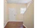 Inviting entryway with hardwood floors, a white door, and a staircase leading to the upper level at 257 Ridge Mill Dr, Acworth, GA 30102