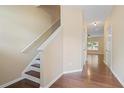 Hallway featuring hardwood floors, a staircase, and views into other rooms, creating an open feel at 257 Ridge Mill Dr, Acworth, GA 30102