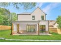 Backyard featuring a covered patio with brick accents and a spacious lawn perfect for outdoor entertaining at 504 Barrington Drive, Roswell, GA 30075