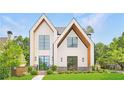 Beautiful modern farmhouse exterior with gabled roof and manicured lawn at 504 Barrington Drive, Roswell, GA 30075