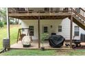 Cozy patio area with an open area under the elevated deck, offering shade and space for relaxing outdoors at 10 Stagg Trce, Social Circle, GA 30025
