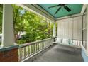 Relaxing front porch featuring a swing and views of the beautifully landscaped front yard at 1038 Saint Charles Ave, Atlanta, GA 30306