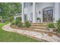 Stone walkway leading to the main entrance with double doors and decorative landscaping at 111 Cherry Hill Dr, Marietta, GA 30067