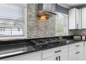 This is a detailed view of the kitchen's countertop and appliances, including a gas cooktop at 1647 Grandeus Sw Ln, Stone Mountain, GA 30087