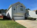 Inviting two-story home featuring a two-car garage and lush green lawn at 3889 Sidney Lanier Blvd, Duluth, GA 30096