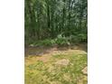 View of the backyard featuring a stone retaining wall and a small patch of grass at 4766 Jamerson Forest Cir, Marietta, GA 30066