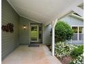 Welcoming covered entrance framed by landscaped greenery with white pillars and contemporary lighting at 4766 Jamerson Forest Cir, Marietta, GA 30066