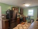 Kitchen featuring dark cabinets, granite countertops, and stainless steel appliances at 1130 Monfort Rd, Lawrenceville, GA 30046