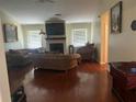 Spacious living room with a fireplace, large windows, and hardwood floors at 1130 Monfort Rd, Lawrenceville, GA 30046