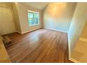 Bright and airy living room featuring wood-look floors and a large window, creating a welcoming space at 4610 Idlewood Park, Lithonia, GA 30038