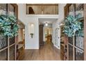 Elegant foyer with hardwood floors, high ceilings, and a view of the upper level at 505 Woodmoore Ct, Sandy Springs, GA 30342