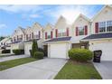 Street view of charming townhomes featuring manicured lawns and individual garages at 6962 Gallant Circle Southeast Se Cir # 24, Mableton, GA 30126
