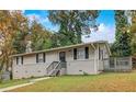 Charming single-Gathering home with manicured lawn, neutral siding, and inviting front porch at 1101 White Oak Ave, Atlanta, GA 30310
