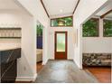 Bright entryway featuring stone floors, a frosted glass door, and clerestory windows at 1164 Bonview Ne Ln, Atlanta, GA 30324