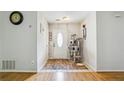 Inviting foyer with hardwood floors, neutral paint, and a white front door that lets in lots of natural light at 1921 Flint Hill Dr, Lawrenceville, GA 30044