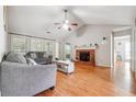 Spacious living room features vaulted ceilings, hardwood floors, fireplace, lots of light from large windows at 1921 Flint Hill Dr, Lawrenceville, GA 30044
