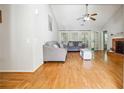 Bright living room with vaulted ceiling, hardwood floors, ceiling fan, a fireplace and lots of natural light at 1921 Flint Hill Dr, Lawrenceville, GA 30044