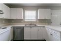 Well-lit kitchen boasts ample storage, stainless steel dishwasher and light countertops at 256 Turnstone Rd, Stockbridge, GA 30281